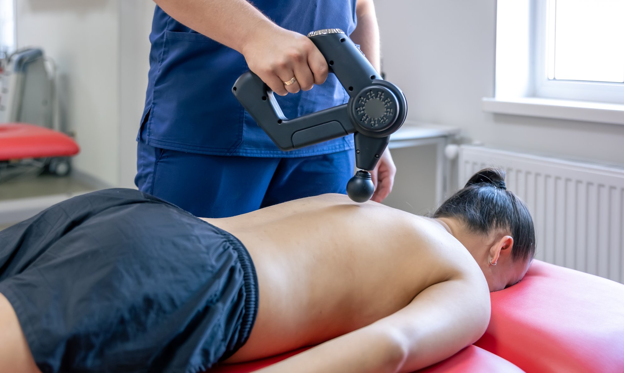 sports-percussion-massage-in-medical-room-of-gym-2025-03-14-03-02-08-utc